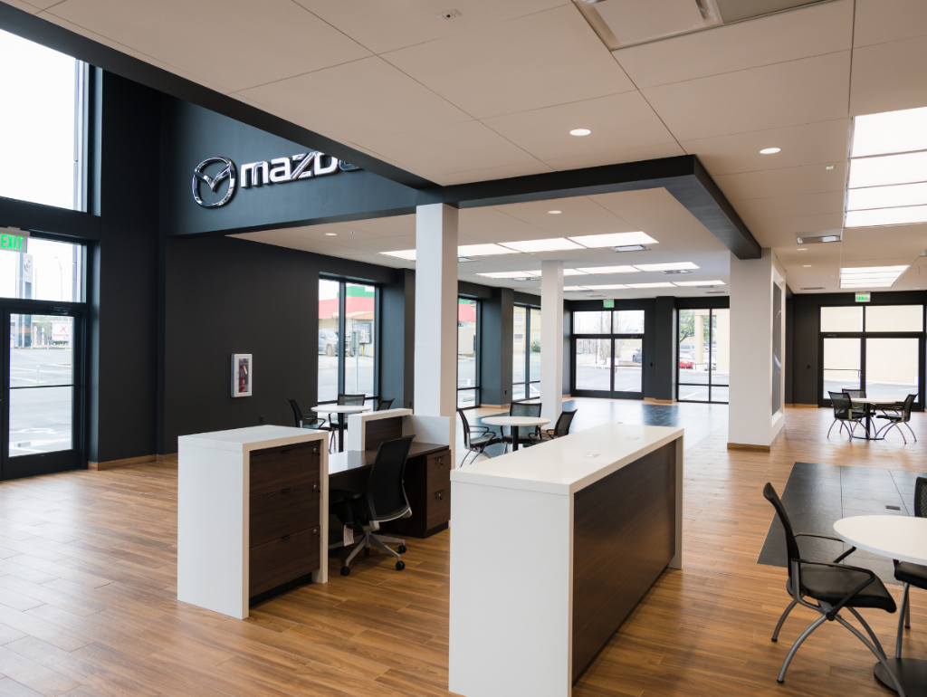 spacious Mazda dealership showroom with modern furniture and large windows