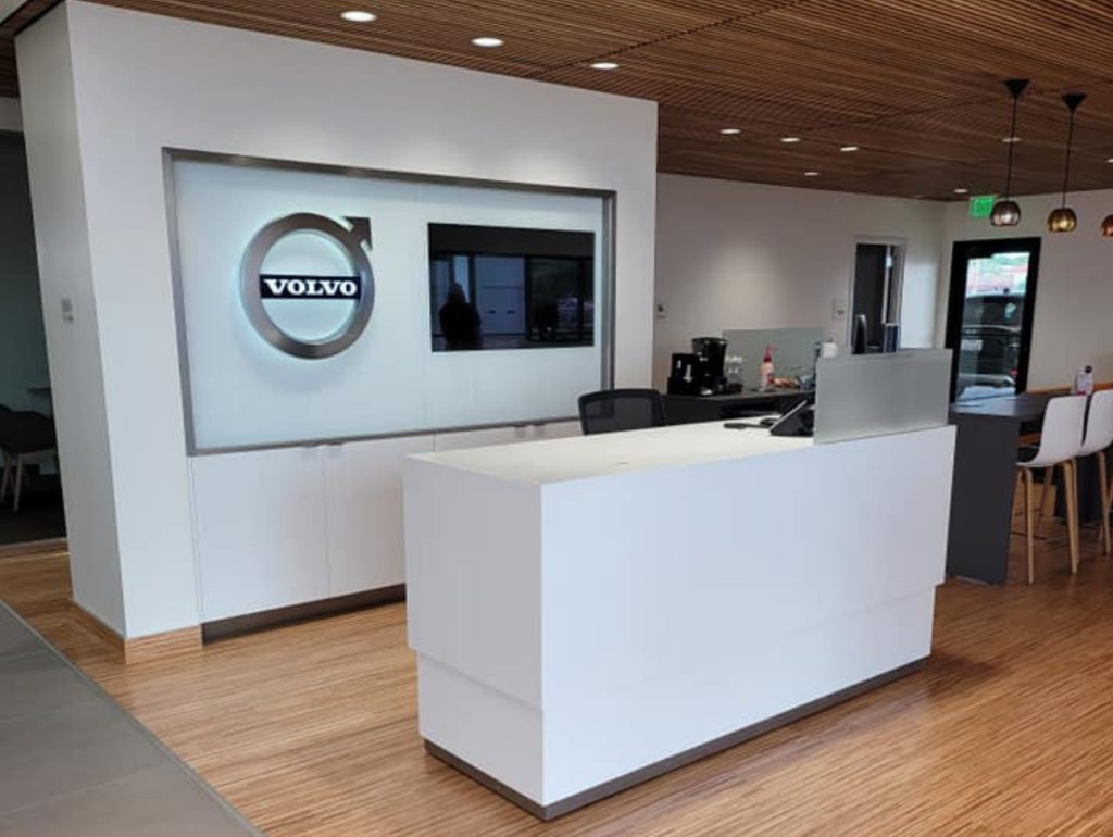 modern Volvo dealership reception area with wooden flooring and ceiling